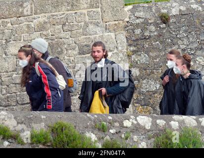 Penzance, Großbritannien. Mai 2021. Cornwall UK, St. Michaels Mount, House of Dragon. Viele der Darsteller ohne Gesichtsmasken. Die Schauspieler kehren von der Insel über eine halbe Meile offenes Meer zurück, eingewickelt in wasserfeste Umhänge, um die teuren Kostüme zu schützen. Eine raue Bootsfahrt von den Dreharbeiten auf der Insel St. Michaels Mount bis zur Hafenmauer von Marazion. April 2021. Kredit: Robert Taylor/Alamy Live Nachrichten Stockfoto