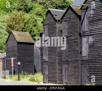 Staycation Idee. Alte historische Holznetzgeschäfte waren traditionelle Lagergebäude für die Fischereiflotte im Stade, Hastings, East Sussex, England Stockfoto