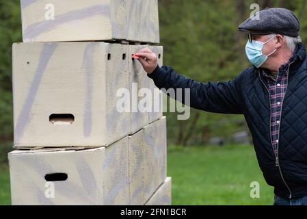 Wachstedt, Deutschland. Mai 2021. Ein Gläubiger schreibt in der Klagemauer auf den Weg zur alternativen Pilgerfahrt für Männer unter dem Motto "Komm, Herr, segne uns". Himmelfahrt ist der Tag der Männerwallfahrt nach Klüschen Hagis in der Diözese Erfurt. Wie im vergangenen Jahr wird die traditionelle Wallfahrt wegen Corona abgesagt. Quelle: Swen Pförtner/dpa/Alamy Live News Stockfoto