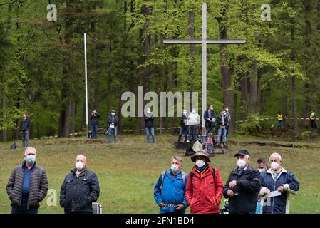 Wachstedt, Deutschland. Mai 2021. Gläubige mit Mund-Nase-Schutz stehen bei der alternativen Männerwallfahrt unter dem Motto 'Komm Herr, segne uns' vor einem Holzkreuz in der Wallfahrtskirche Klüschen Hagis. Das Fest Christi Himmelfahrt ist der Tag der Männerwallfahrt nach Klüschen Hagis in der Diözese Erfurt. Wie im vergangenen Jahr wurde die traditionelle Wallfahrt aufgrund der Korona abgesagt. Quelle: Swen Pförtner/dpa/Alamy Live News Stockfoto
