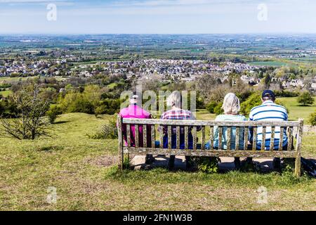 Vier Spaziergänger genießen den Blick über die Stadt Broadway in Worcestershire und das Valle of Evesham vom Cotswold Way-Fernwanderweg aus. Stockfoto