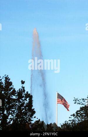 Lynchburg, VA, USA. Wasserstrahl aus dem Langley-Brunnen, der hinter einer amerikanischen Flagge zu sehen ist. Stockfoto