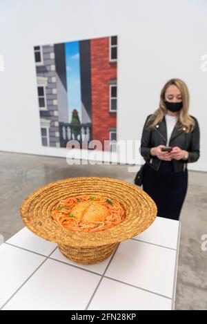 London, Großbritannien. 13 Mai 2021. Ein Angestellter sieht „Maze Meal“, 2019, von Julie Curtiss. Vorschau auf „Monads and Dyads“, die erste Londoner Ausstellung der in New York lebenden Künstlerin Julie Curtiss. Ihre surrealistischen Arbeiten zeigen neue Gemälde, Arbeiten auf Papier und Skulpturen. Die Show findet vom 14. Mai bis 26. Juni 2021 im White Cube Mason’s Yard in Mayfair statt. Kredit: Stephen Chung / Alamy Live Nachrichten Stockfoto