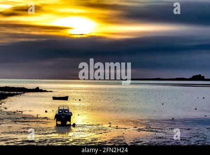 Bamburgh Castle von rund um den Hafen auf Holy Island, Northumberland, aus gesehen. Stockfoto