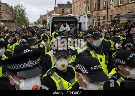 Glasgow, Großbritannien. Mai 2021. Eine Demonstration in der Kenmure Straße im Gebiet Pollokshields der Stadt, um gegen die Inhaftierung von zwei eingewanderten Männern durch Immigrationsgefangenenbeamte zu protestieren, wurde von einer starken Polizeipräsenz getroffen, als Demonstranten Straßen blockierten, die den Ausstieg des Einwanderungswagens verhinderten. Nach stundenlangen Verhandlungen wurden die Einwanderer kostenlos freigelassen. Foto: jeremy sutton-hibbert/Alamy Live News Stockfoto