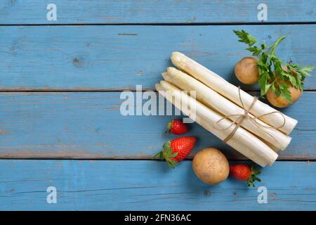 Frischer bayerischer weißer Spargel aus Schrobenhausen auf schäbig türkisfarbenem Platten mit Kopierplatz Stockfoto