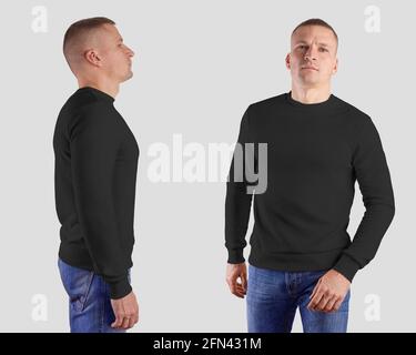 Schablone unbeschriftter männlicher Pullover mit langem Arm, auf einem Sportmann in Jeans, vorne, seitlich, isoliert auf weißem Hintergrund. Schwarzes Mockup-Sweatshirt für PR Stockfoto