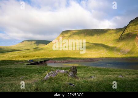 Llyn y Fan Fach Lake unterhalb des Abhangs der Carmarthen Fans (Bannau Sir Gaer) im Bannau Brycheiniog (Brecon Beacons) National Park, Carmarthenshire, Südwales. Stockfoto