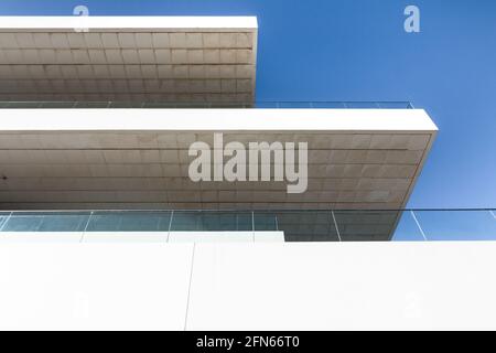 Blick auf die Terrassen eines modernen minimalistischen weißen Betongebäudes mit Blick auf den blauen Himmel. Architekturkonzept Stockfoto