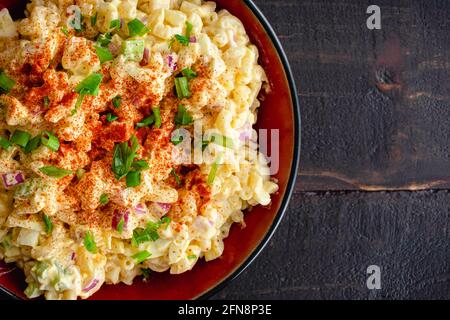 Deviled Egg Pasta Salat in einer Servierschüssel: Eine große Schüssel mit Makkaroni-Salat aus hart gekochten Eiern Stockfoto