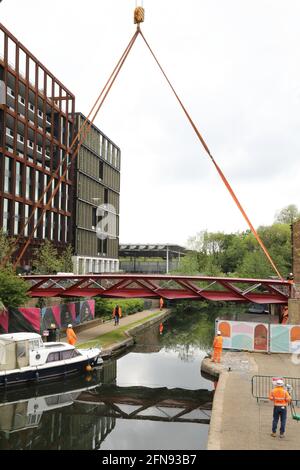 London, Großbritannien, 15. Mai 2021, Neue Fußgängerbrücke wird über den Regents Canal am Granary Square am Kings Cross installiert. Menschenmengen versammelten sich, um zuzusehen und jubelten über die Fertigstellung. Monica Wells/Alamy Live News Stockfoto