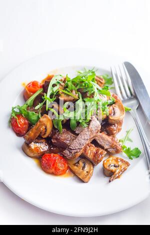 Saftiges Steak mittelseltenes Rindfleisch mit Rucola und gegrilltem Gemüse. Draufsicht Stockfoto