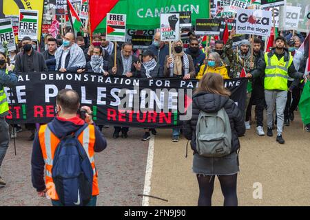 London, Großbritannien. Mai 2021. Demonstranten versammeln sich vor der israelischen Botschaft in London zu einer nationalen Demonstration in Solidarität mit Palästina. Ein großes Banner lautet: „FREIES PALÄSTINA – WIDERSTAND – RÜCKKEHR!“ Mit Plakaten, die ein Ende der Belagerung von Gaza fordern. Zu den Teilnehmern gehören maskierte Demonstranten, Aktivisten und Verwalter in gut sichtbaren Westen. protestmarsch vom Marble Arch zur israelischen Botschaft in Knightsbridge. Penelope Barritt/Alamy Live News Stockfoto