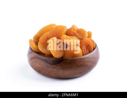 Getrocknete Aprikosen in Holzschüssel isoliert auf weiß Stockfoto