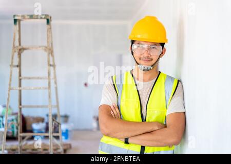 Portrait des asiatischen Ingenieurs oder Architektur und Bau Geschäftskonzept - Geschäftsmann oder Architekt in Helm auf der Baustelle, Gebäude Stockfoto
