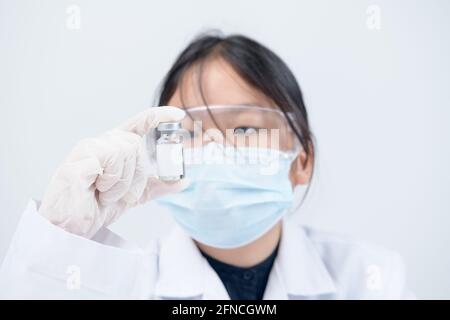 Wenig Wissenschaftler oder Arzt hält Impfstoff auf weißem Hintergrund. Gesund und Medizin Konzept Stockfoto