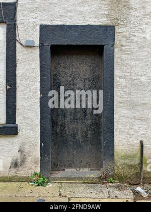 Schwarz lackierte Tür und Tür in weißer Wand und verstopft Fenster nach oben Stockfoto