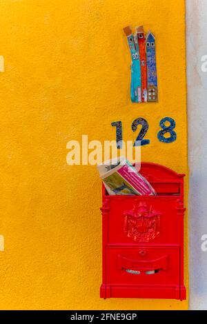 Briefkasten und Hausnummer auf einer gelben Hauswand, Burano Island, Venedig, Venetien, Italien Stockfoto