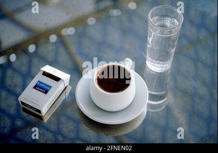 Kaffee wird in Griechenland immer von einem Glas Wasser begleitet, und Zigaretten sind auch ein muss für die Pause. [Automatisierte Übersetzung] Stockfoto