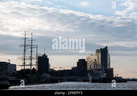 Hamburg, Deutschland. Mai 2021. Wolken ziehen mit der Elbphilharmonie über die Skyline des Hafens an der Elbe. Quelle: Daniel Bockwoldt/dpa/Alamy Live News Stockfoto