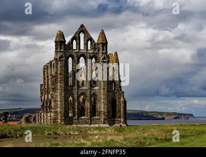 Whitby Abbey auf seiner hohen Position auf dem East Cliff über dem historischen Hafen von Whitby. Stockfoto