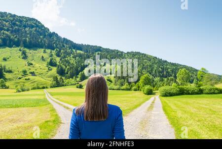 An der Kreuzung der Straßen. Das Symbol soll eine Wahl treffen. Weibliche Figur. Stockfoto