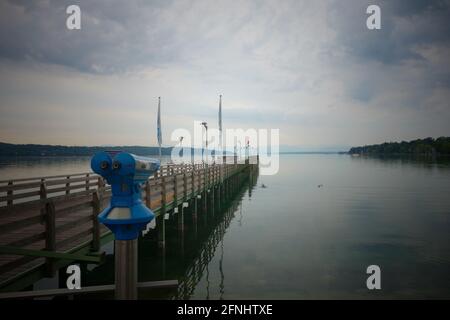 Blick auf einen See von einem hölzernen Steg. Im Vordergrund ein Teleskop für Touristen. Stockfoto