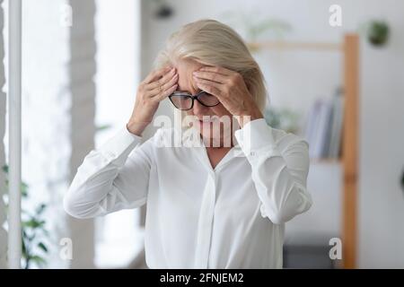 Eine ungesunde weibliche leitende Angestellte leidet unter Kopfschmerzen Stockfoto