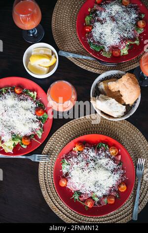 Serviert Tisch zu Hause mit hausgemachtem italienischen Carpacio, frischem Brot, Saft. Stockfoto