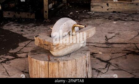 Eine alte Mühle in einer authentischen Schmiede. Waffenherstellung in alten Zeiten. Alte Steinausrüstung Stockfoto