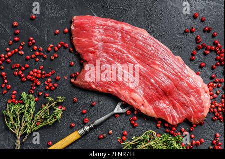 Rohes Flankensteak mit Rosmarin und rosa Salz. Frisches Marmor Rindfleisch Fleisch schwarz Angus. Schwarzer Hintergrund. Draufsicht Stockfoto