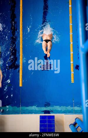 Männlicher professioneller Schwimmer im Schwimmbad Stockfoto