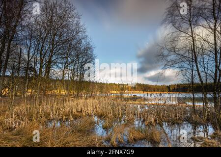 Kleiner holziger Fischerpier am See. Moody Farben des Sonnenuntergangs. Okuniewo, Woiwodschaft Pommern, Polen. Stockfoto
