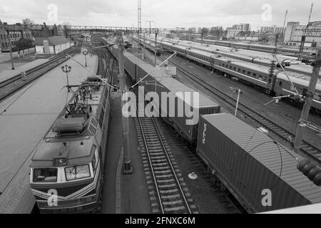 Personenzug, der am Bahnhof geparkt ist, Draufsicht. Lokomotive und Güterzug. Schwarzweiß-Bild. Stockfoto