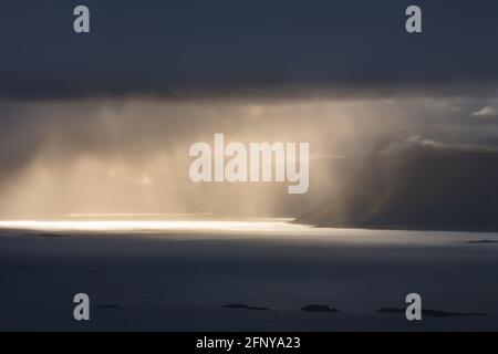 Sonnenstrahlen über der felsigen Küste Norwegens Stockfoto