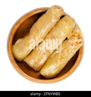 Gefüllte Kohlblätter, in einer Holzschüssel. Vegane Kohlrollen, gekochte Kohlblätter, umwickelt um eine Füllung aus Reis, Zwiebeln und Gewürzen. Nahaufnahme. Stockfoto