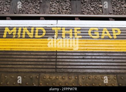 Beachten Sie die Lücke Text auf dem Boden in a geschrieben Die U-Bahn von London aus der Nähe Stockfoto