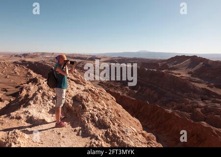 Ein Tourist fotografiert die atemberaubende Wüstenlandschaft in der Nähe von San Pedro De Atacama, Chile. Stockfoto