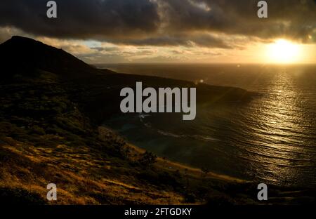 Ruhiger, ruhiger Sonnenaufgang über der Hanauma Bay, einem der beliebtesten Reiseziele für Schnorcheln und Schwimmen, und dem Koko Head Crater, Oahu, Honolulu, Hawaii, USA Stockfoto