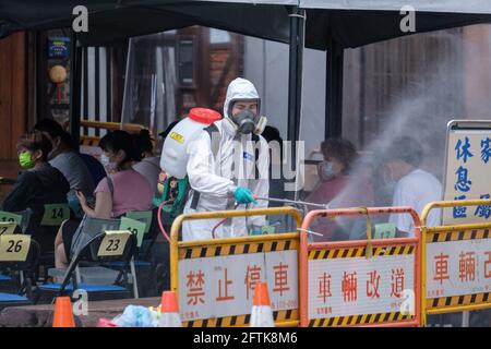 Taipeh, Taiwan. Mai 2021. Militärangehöriger sprühen Desinfektionsmittel, während Bewohner darauf warten, auf COVID-19 in Wanhua getestet zu werden.Taiwan bestätigte 315 neue Fälle von COVID-19, nachdem die Behörden die COVID-19-Warnung landesweit auf Stufe 3 angehoben hatten. Kredit: SOPA Images Limited/Alamy Live Nachrichten Stockfoto