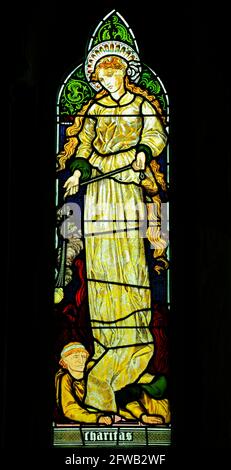 Charitas, Charity, Glasfenster von Burne-Jones, 1865, Sculthorpe Church, Norfolk, England, Aus dem Fenster „Glaube, Hoffnung und Nächstenliebe“ Stockfoto