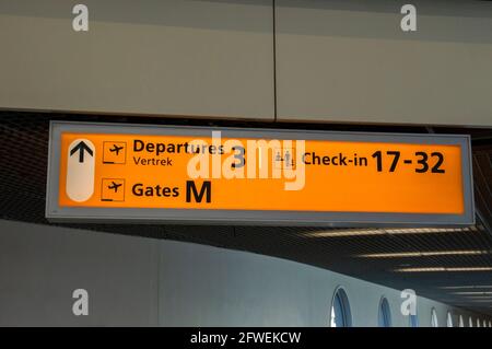 Abflug und Check-in an den Werbetafeln sowie an den Gates M und Gates um Schiphol Niederlande Stockfoto