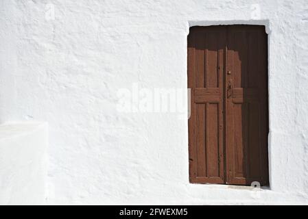 Landhaus antike hölzerne Tür auf einer weißgetünchten Wand in Amorgos Insel, Kykladen Griechenland. Stockfoto