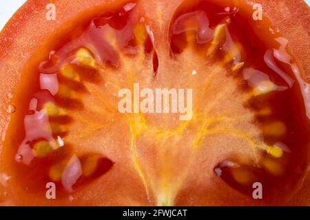 Makrofoto eines Teils der Halbschnitt-Tomate. Nützlich als Hintergrund Stockfoto