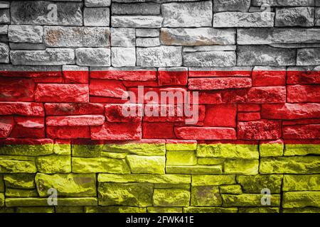 Nationalflagge von Ossetien auf Steinmauer Hintergrund.das Konzept der nationalen Stolz und Symbol des Landes. Flag Banner auf Stein Textur Hintergrund. Stockfoto