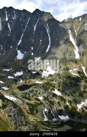 Landschaft in der Hohen Tatra mit Bergen, dem Tal Mlynicka dolina, dem See Pleso nad Skokom und dem Wasserfall Vodopad Skok. Slowakei. Stockfoto