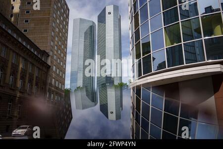 24. Mai 2021, Hessen, Frankfurt/Main: ILLUSTRATION - die Zwillingstürme des Hauptquartiers der Deutschen Bank spiegeln sich auf dem Bildschirm eines Smartphones wider. Die Hauptversammlung der Frankfurter Dax-Gruppe wird am Donnerstag (27.05.) wegen der Pandemie wieder online stattfinden. Foto: Frank Rumpenhorst/dpa Stockfoto