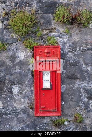 Roter Briefkasten für Wandmontage, Tarbert, Argyll, Schottland. Stockfoto