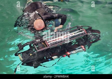 Das autonome Unterwasser-Fahrzeug „Nova“ 2009 der Cornell University (AUV); kurz vor der Freigabe; Taucher, der die Küstenanbinder abtrennt; Hebegerät. SPAWAR Transducer Test Facility; San Diego; 12th International Autonomous Underwater Vehicle Competition; gesponsert von der Association for Unmanned Vehicle Systems International (AUVSI) und dem US Office of Naval Research. August 2; 2009. Die Mission ist es, ein Tauchfahrzeug zu schaffen, das autonom agiert (getrennt von der menschlichen Richtung oder Forts Stockfoto