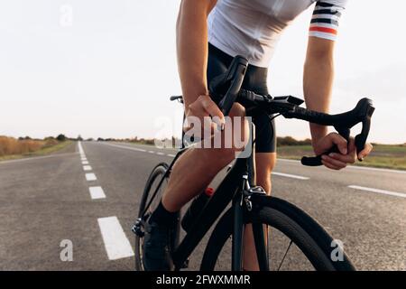 Professioneller Rennradfahrer posiert mit dem Fahrrad vor der Kamera Stockfoto